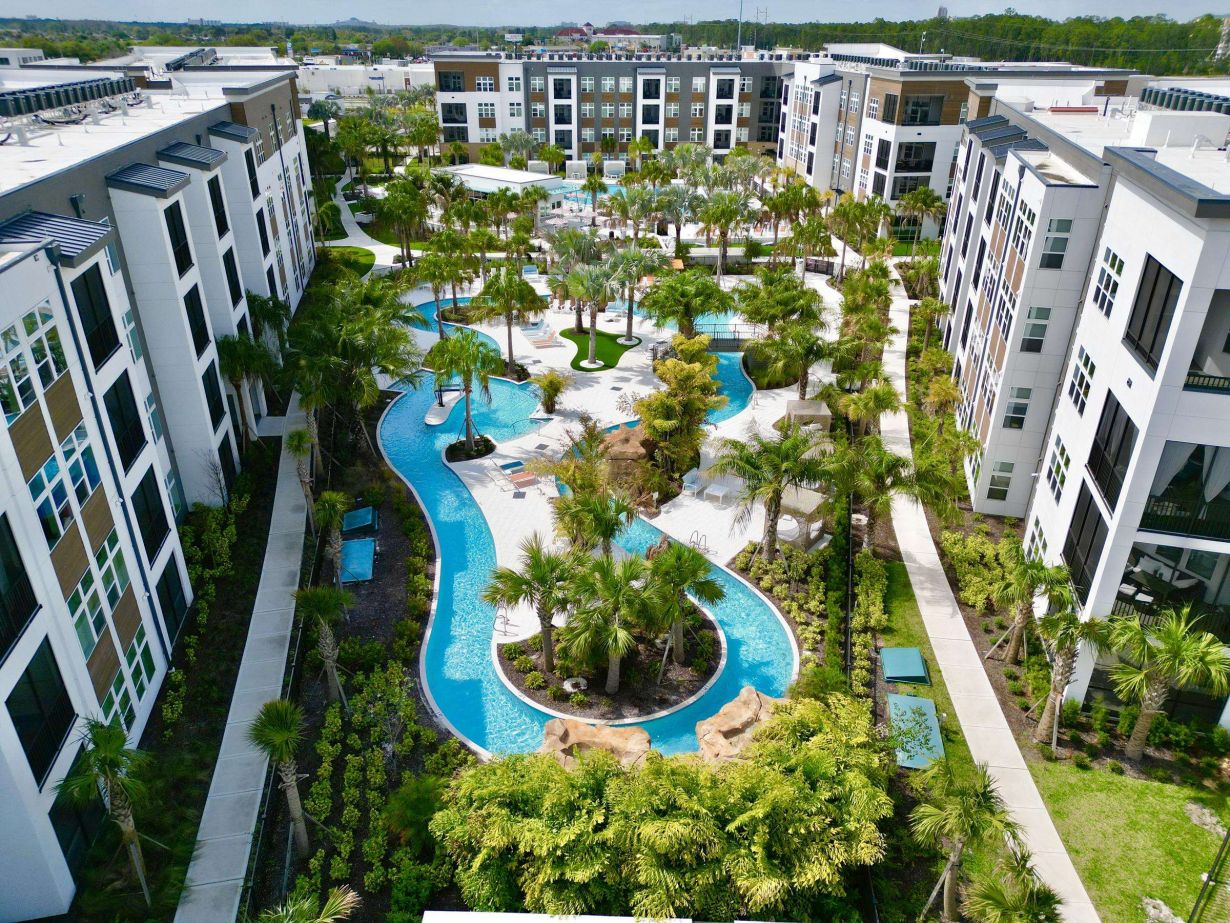 Northwood Ravin Property Management Portfolio, THE LUCENT AT SUNRISE in Kissimmee, FL, multi-family, multi-story apartments with balconies, green grass and palm trees