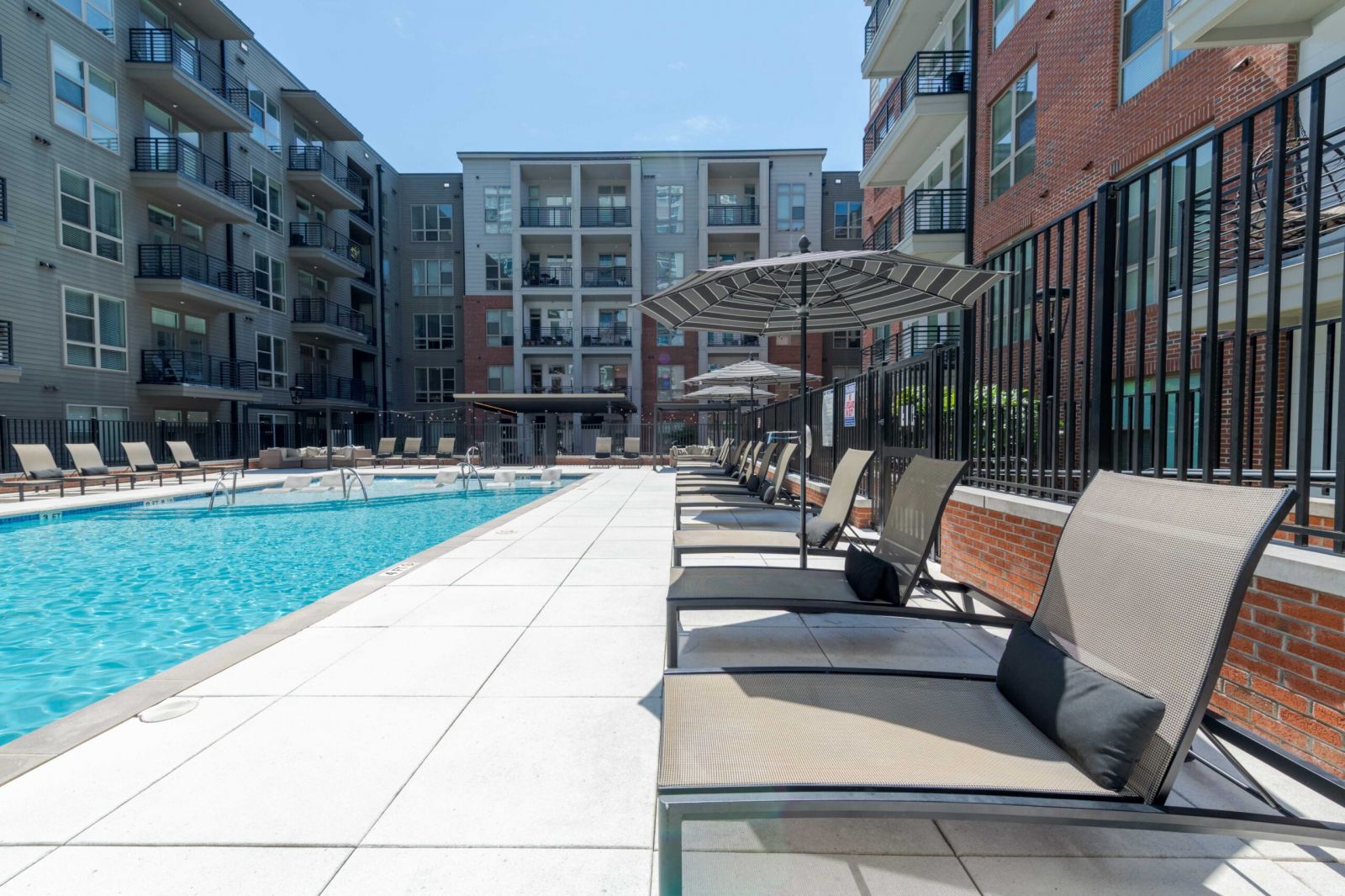 Northwood Ravin Property Management Portfolio, THE LUCENT AT SUNRISE in Kissimmee, FL, multi-family, multi-story apartments with balconies, green grass and palm trees