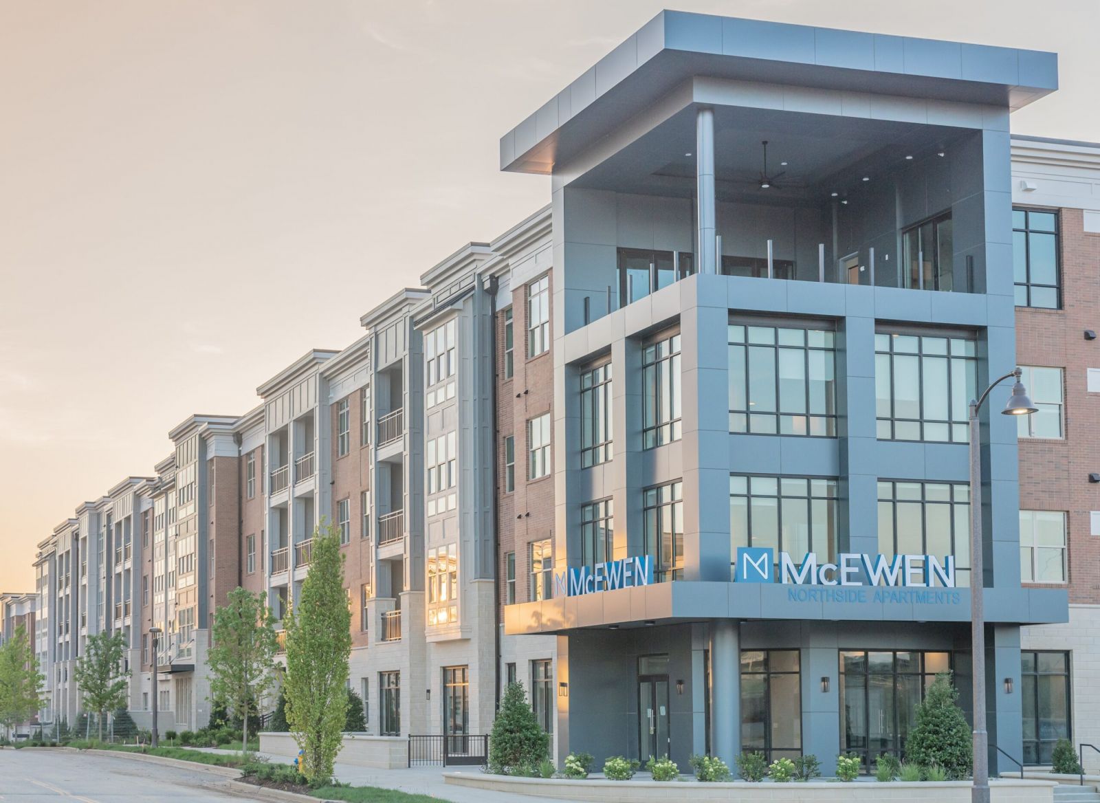 Northwood Ravin Property Management Portfolio, THE LUCENT AT SUNRISE in Kissimmee, FL, multi-family, multi-story apartments with balconies, green grass and palm trees